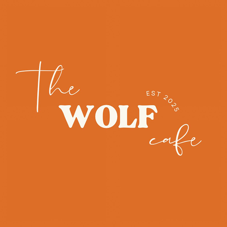 Orange background with the words The Wolf Café in white, decorative fonts. EST 2025 is written in small text above café. The overall style is modern and clean.